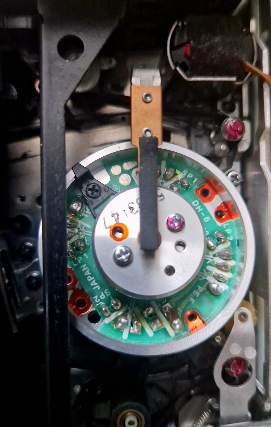 Close-up of a video tape head mechanism inside a professional playback deck