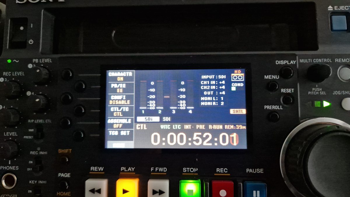 Close-up of a professional Sony broadcast deck display showing timecode and audio levels